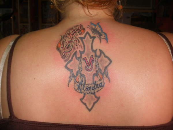a cross with her sons names and butterflie tattoo