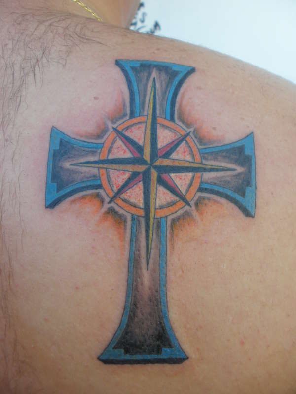 cross with the direction star in the middle tattoo