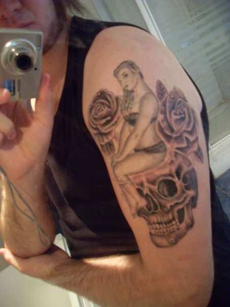 Pin-up Sat On Skull With Roses tattoo