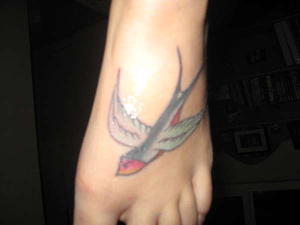 Swallow [left] tattoo