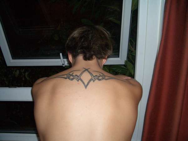 Custom tribal ink, across top of my back tattoo