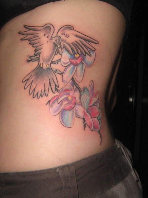 Dove with orchids tattoo