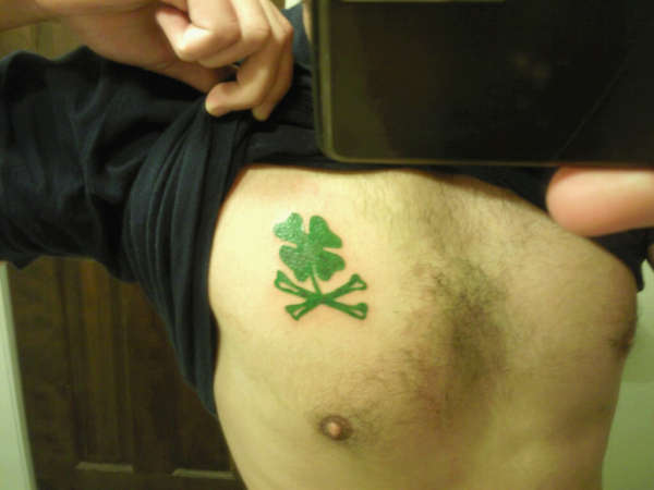 Clover crossbones tattoo