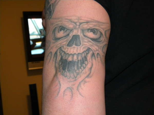 skull on elbow tattoo