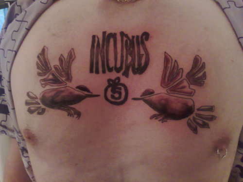 Incubus chest piece tattoo