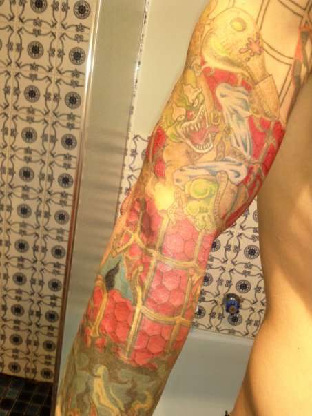 crazy clown swinging on spider man sleave tattoo