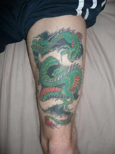dragon on thigh tattoo