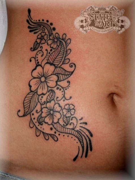 Black work flowers on hip tattoo