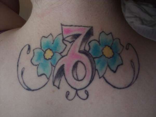 Capricorn with flowers tattoo