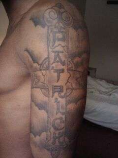My name "PATRICK" in a cross tattoo