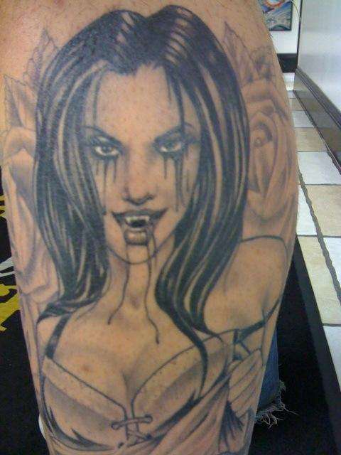 vampire w skulls and roses close up tattoo