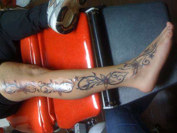 Flowers and tribal tattoo