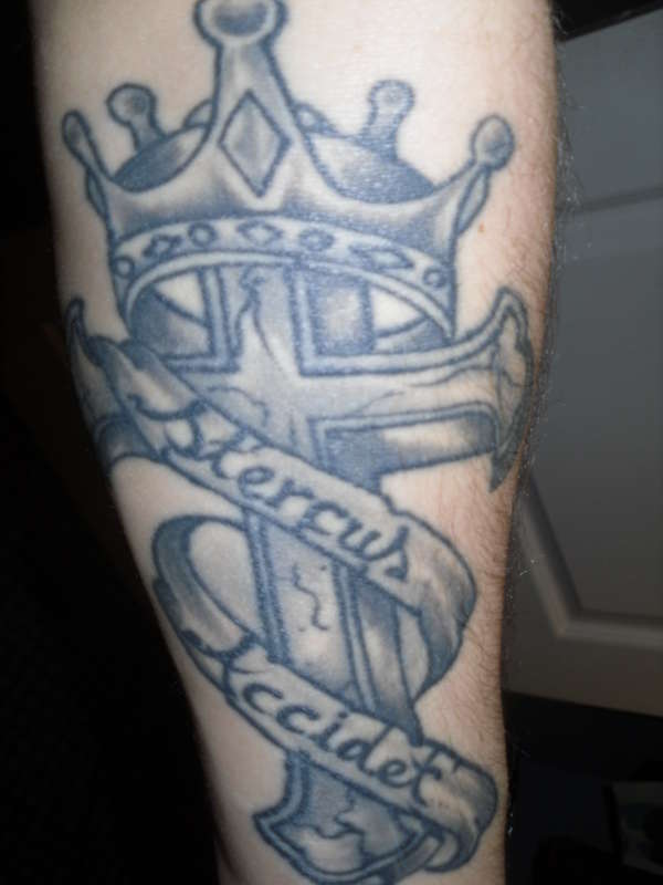 A Cross and crown, says Shit Happens in Latin. tattoo