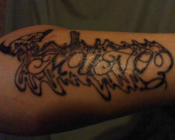 My mans last name with skull. tattoo