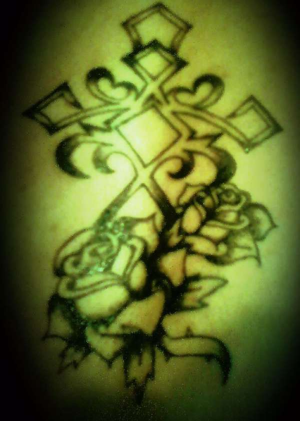 Tribal cross with roses tattoo