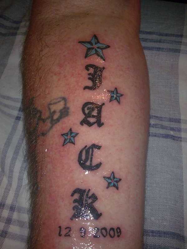 old english with stars forearm tattoo