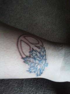 peace sign and pot leaf tattoo