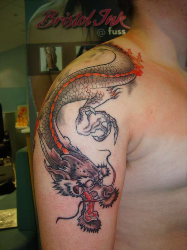 Dragon over shoulder tattoo