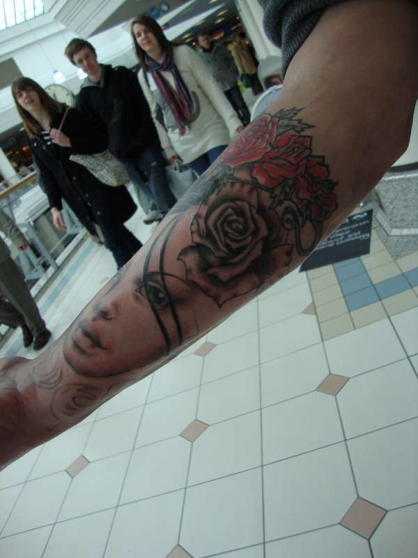 Girl with roses sleeve tattoo