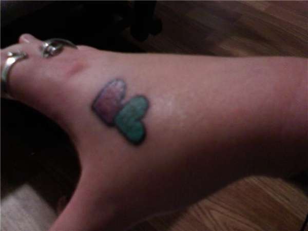 Hearts on right hand tattoo