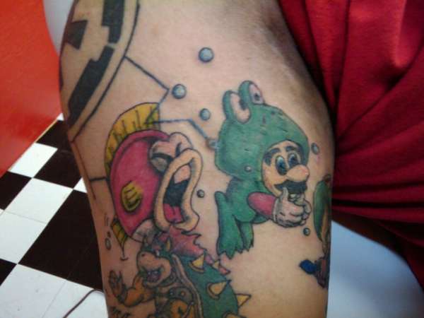 Mario in a frog suit with angry fish close behind tattoo