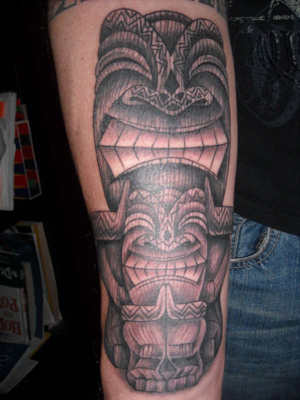 Tribal statue tattoo on forearm tattoo