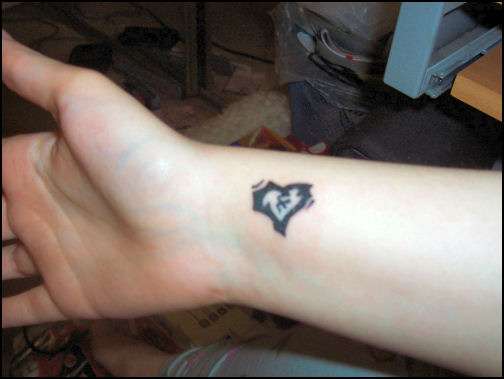 stitched-up heart tattoo