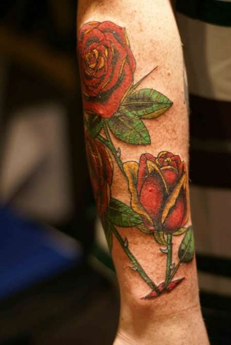 roses below elbow tattoo