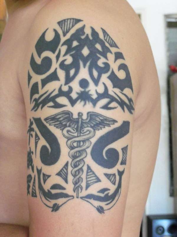 tribal with caduceus symbol tattoo