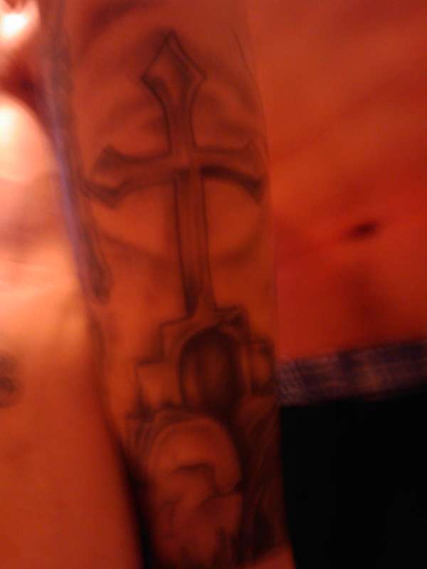 Cross on tombstones tattoo