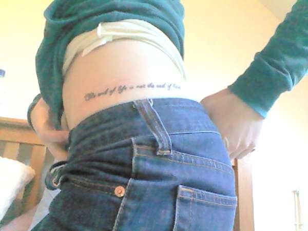 Lettering on hip tattoo