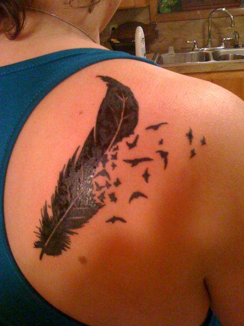 Feather with birds breaking off tattoo
