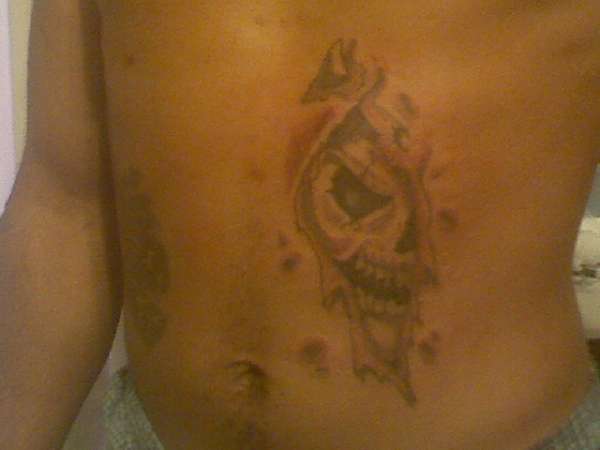 Ripped skull tat tattoo