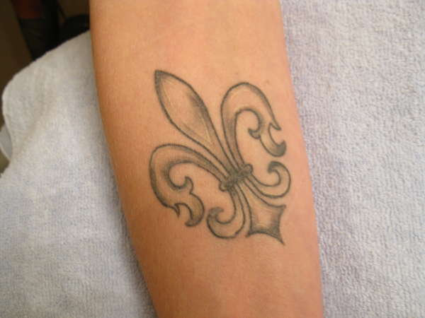 Fleur de lis on arm tattoo