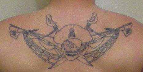 Pirate, skull and cutlass, upper back tattoo