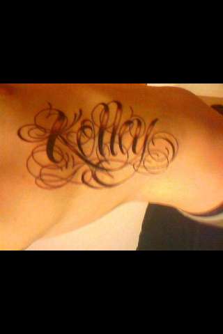 last name on ribs tattoo