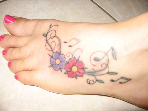 musical floral foot tattoo