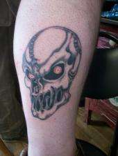 Skull with red eyes tell me what you think tattoo