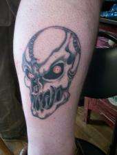 Skull with red eyes tell me what you think tattoo