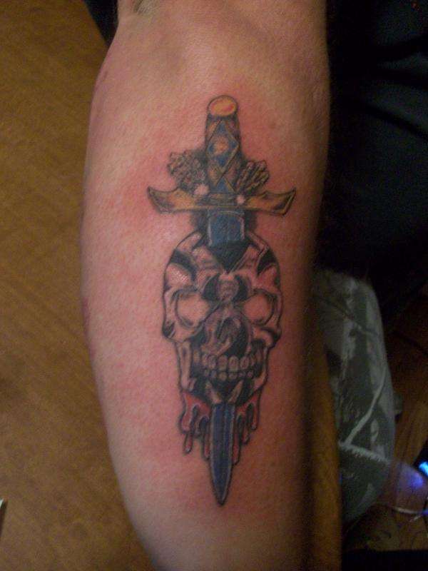 tribal skull and dagger as a cover up for a name tattoo