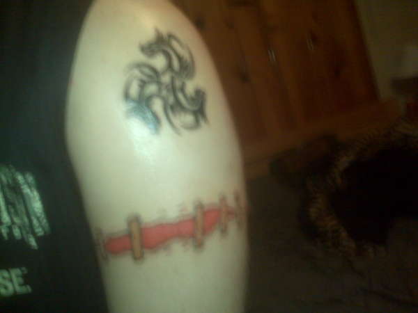 Staple Armband and Triple Dragon Piece tattoo