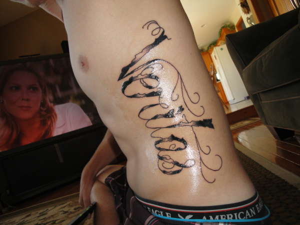 Veritas (left rib) tattoo