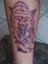 WOLF ON EDGE OF CLIFF. tattoo