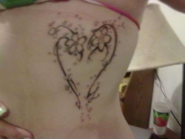 Heart with flowers on my ribcage. tattoo