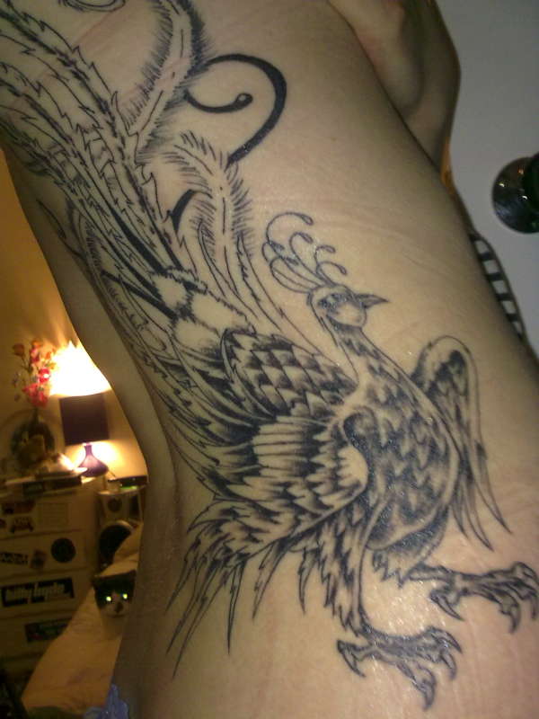 Peacock on my hip, back and ribs. tattoo