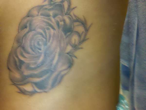 Rose on ribcage tattoo