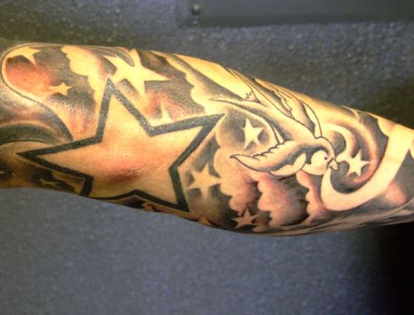 black and grey stars and clouds tattoo
