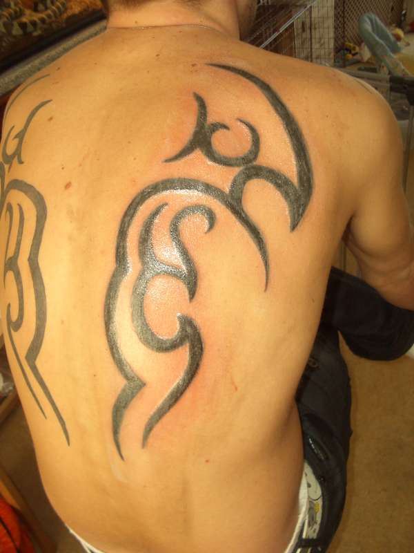 tribal back piece tattoo