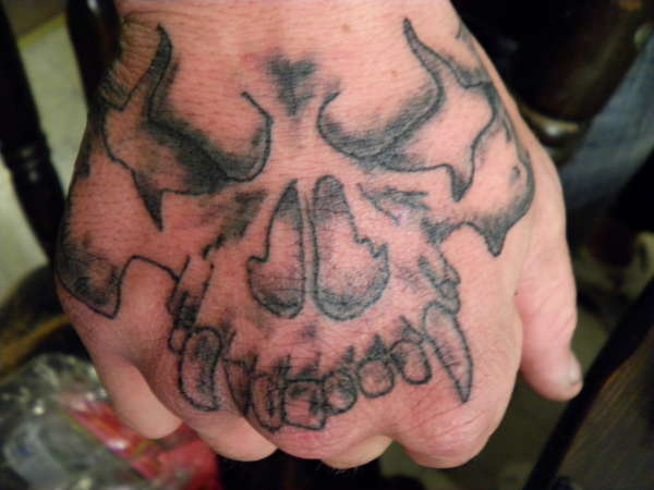 A skull on hand tattoo