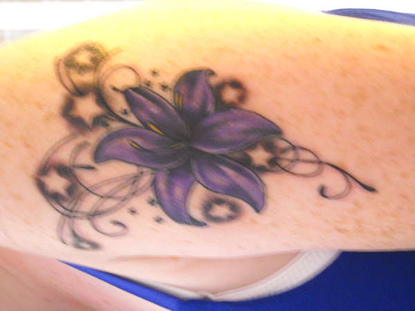 Lily with stars tattoo